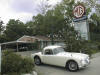 Photo of a MGA coupe and our sign