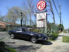 Photo of a Jaguar E-Type and our sign