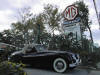 A photo of a Jaguar XK140 and our sign